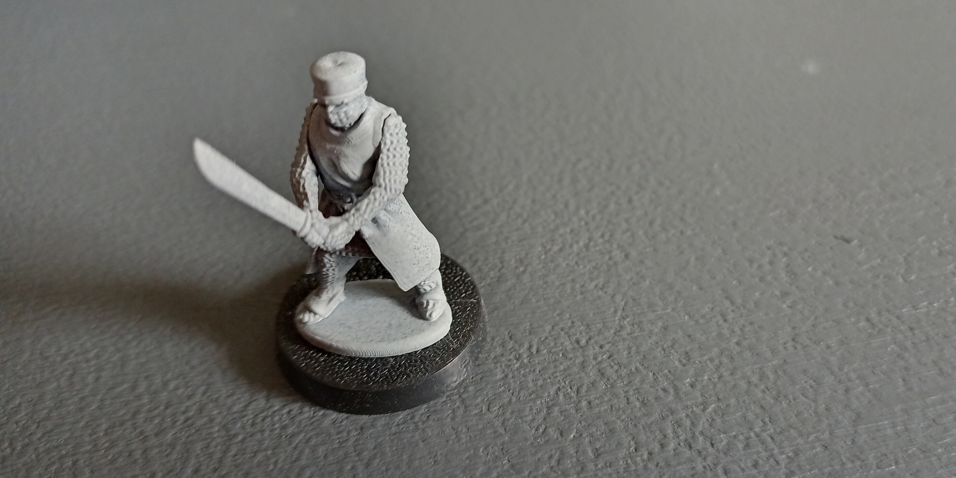 A base glued to an assembled model, and a puddle base molded as part of a model