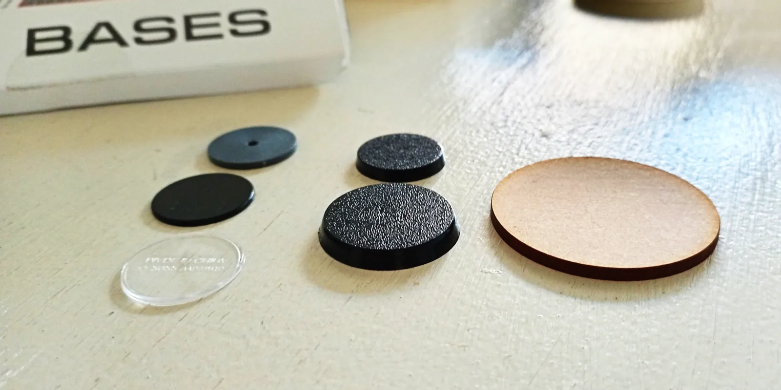 various miniature bases, of different sizes and made of different materials